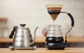 Close up of coffee brewing gadgets on wooden bar counter. Percolation - Not Just an Old Fashioned Way to Make Coffee