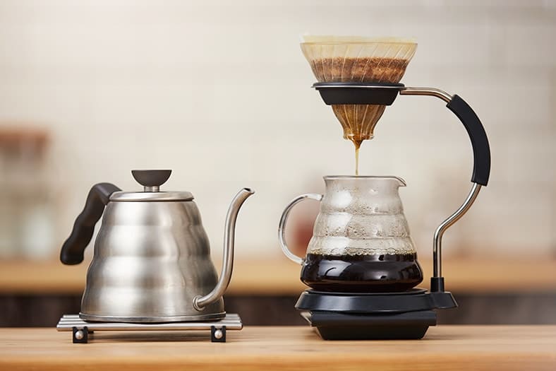 Close up of coffee brewing gadgets on wooden bar counter. Percolation - Not Just an Old Fashioned Way to Make Coffee