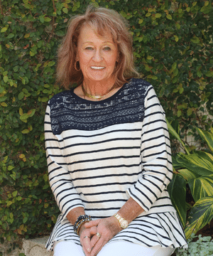 Female dental patient of Beyond Exceptional Dentistry enjoys their courtyard