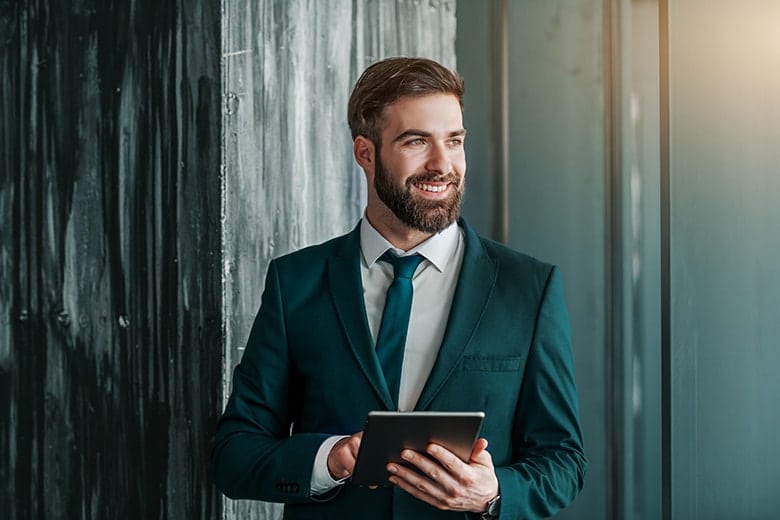 Attractive business man takes a break from working on his iPad
